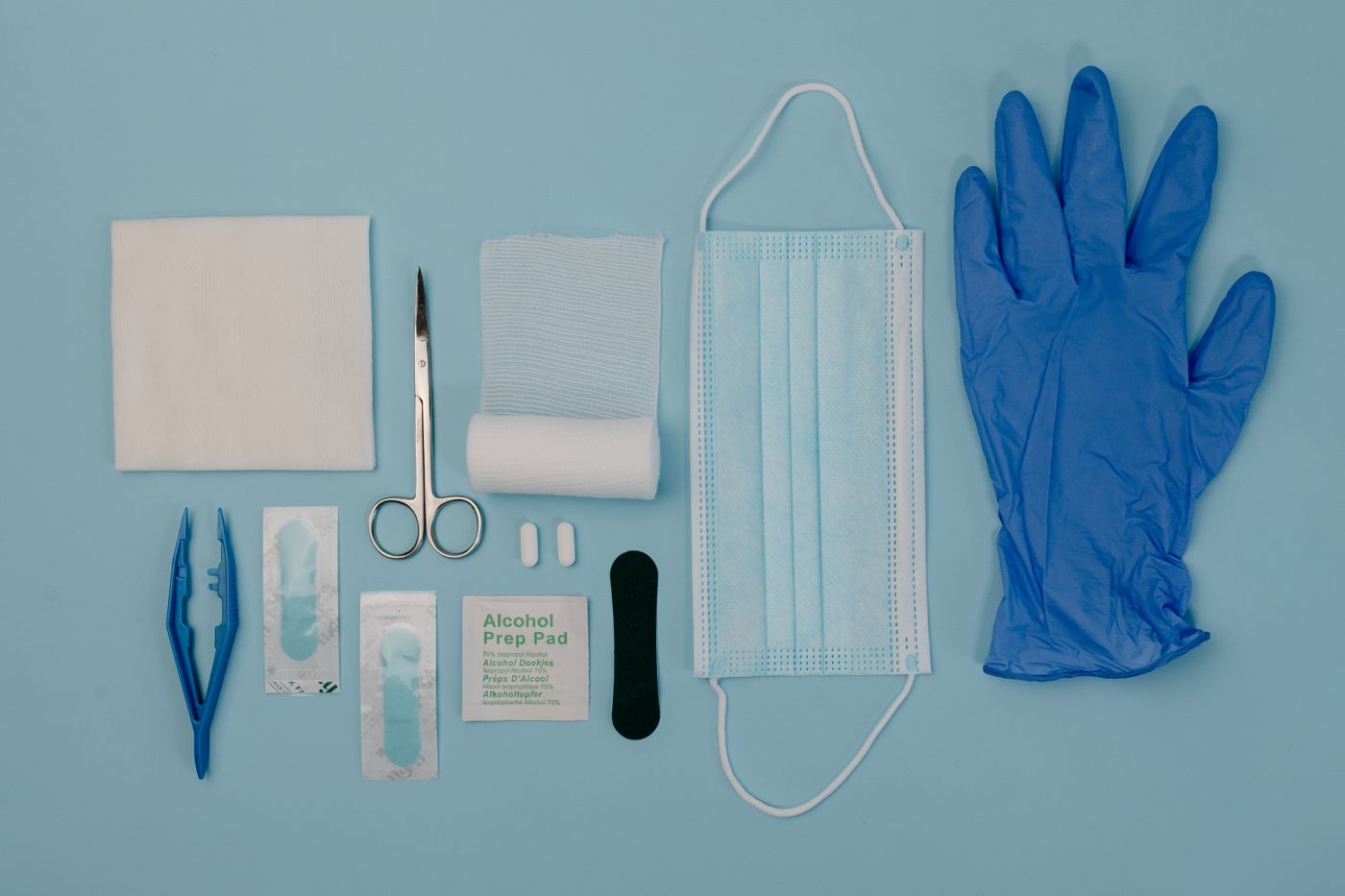 First-aid essentials arranged on a blue surface